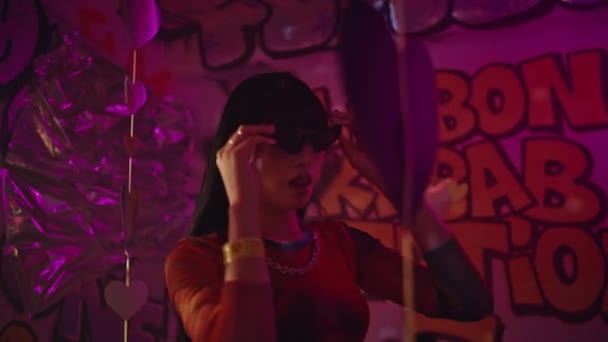 Stylish Clubber Holding Sunglasses Nightclub Exuding Cool Confidence Closeup Asian — 비디오