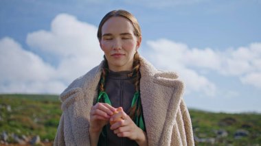 Kırsal alanda yumurta soyan çiftçi kız. Güneşin altında poz veren gülümseyen eko kadın dışarıda piknik kahvaltısında dinleniyor. Örgülü güzel bir model kırsal kesimde kameraya bakıyor. Doğal vejetaryen beslenme 