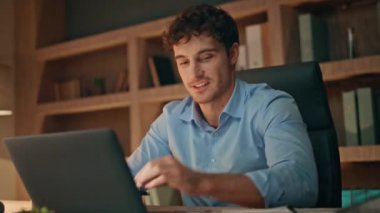 Akşam apartmanında bilgisayarla çalışan yaratıcı girişimci. Gülümseyen serbest çalışan kağıtlar iş verilerini karşılıyor. Mutlu iş adamı raporunu okuyor ve ofiste başarılı oluyor..
