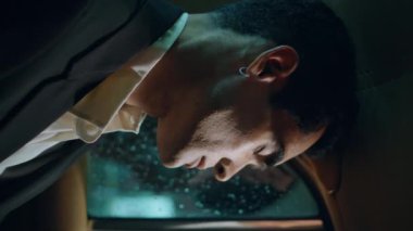 Uyuyan girişimci yağmurlu vitrinli vagonu kapatıyor. Yorgun işadamı, tek başına eve giderken takside dikey videoda dinleniyor. Piercingli adam otomobilin arka koltuğunda dinlenmekten yorgun düşüyor..