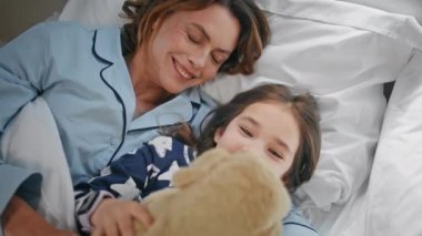 Oyunbaz anne, yatak odasında rahat bir şekilde yatıyor. Tembel bir sabahta rahat bir yatakta oyuncak ayıyı oynayan mutlu, güler yüzlü, komik bir kız çocuğu. Tasasız aile güne eğlenerek başlıyor. Çocukluk kavramı