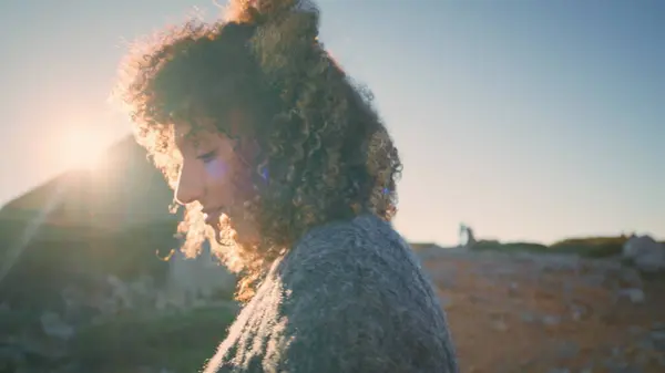 stock image Carefree woman warming sunlight at autumn weather closeup. Young african american girl with curly dark hair looking distance moving hands