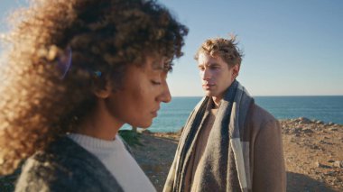 Sahildeki diyalog sahili yakınlaşması üzerine tefekkür eden erkek kadın. Sahilde birbirini görmezden gelen çeşitli ciddi çiftlerin profilleri. Üzgün insanlar.