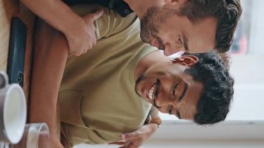 Neşeli geyler kafeteryadaki akıllı telefonları arıyor. Çoklu etnik çeşitliliğe sahip çift cep telefonu kamerasına dikey olarak el sallıyor. Aynı cinsiyetten insanların kahkahaları kafede buluşmanın keyfini çıkarıyor.