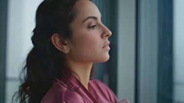 Kızgın kadın pencereye bakıyor, yakından bekliyor. İpek bornozlu göz kamaştırıcı manken lüks bir dairede dinlenen kasvetli şehir manzarasını izliyor. Esmer kız hafta sonu evde. Düz bir evde yaşamayı düşünen ciddi bir kadın.