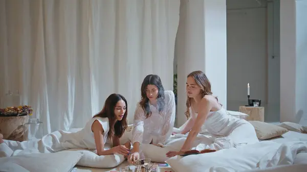 stock image Happy girls enjoying home party on weekend. Beautiful models talking gossiping burning aroma sticks in cozy room. Joyful girlfriends resting spa hotel on holiday. Best friends hang out in relax center