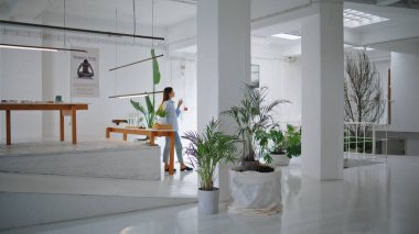 Sanat mağazasında çalışan küçük bir işletme sahibi. Çağdaş galeride su içen düşünceli bir kadın. Huzurlu kadın yönetici sanat eserlerini yudumluyor. Tasarım mağazası çalışanı kameraya bakıyor.