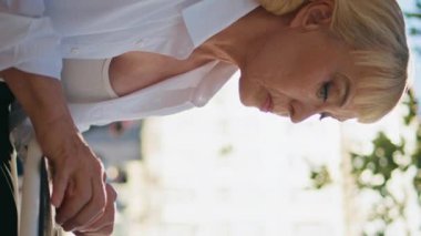 Büyükannem dışarıdaki kafede bilgisayar kullanmakla meşgul. Olgun bir kadın tablet ekranda dikey olarak açık hava restoranını dikey izleyerek kafasını karıştırıyor. Dizüstü bilgisayarda yazı yazan zarif yaşlı kadın..