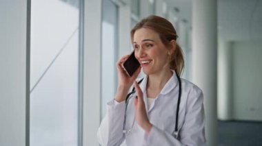 Hastanenin kapanışında mutlu sağlık görevlileri cep telefonlarını arıyor. Akıllı telefondan hastaya danışmanlık yapan neşeli bir doktor. Gülümseyen kadın terapist iyi test sonuçlarını paylaşıyor. Profesyonel sağlık çalışanı..
