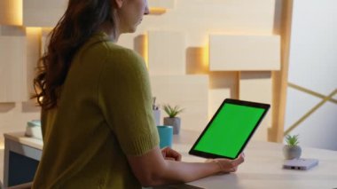 E-ticaret uzmanı, iş yerindeki yeşil ekran tabletinde çalışıyor. Yakınlaştır. Genç bayan girişimci, Mockup Pad Bilgisayar 'da alışveriş uygulamasına göz atıyor. İş kadını Chroma anahtar aygıtı.