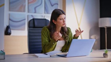 Sanal sohbette konuşan serbest çalışan bir kadın şirket ofisindeki laptop görüntülü web kamerası. Başarılı bir iş kadını iş yerindeki video görüşmesinden zevk alır. Çevrimiçi danışman web sohbetinde kapalı alanda iletişim kuruyor.
