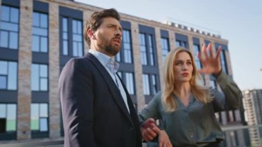Ofisteki iş arkadaşları resmi kıyafetlerle iletişim caddesini kapatıyorlar. Kendine güvenen iş ortakları el kol hareketleri yaparak yüksek binanın dışına bakıyor. Modern kentsel alanda başarılı takım arkadaşları