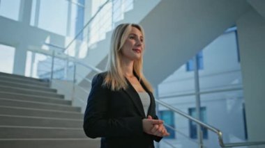 Seçkin bayan patron ofis merdivenlerinde dikilip yakından bakıyor. Sadece şirket merdivenlerinde poz veren başarılı bir iş kadını. Azimli ve hırslı bir ifadeyle gülümseyen kadın yönetici..