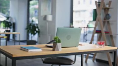 Bilgisayarla birlikte ahşap masa üzerinde modern çalışma alanı. Kablosuz bilgisayarın yer aldığı minimalist çalışma masası tasarımı. Boş parlak profesyonel ofis kurulumu işlevselliği vurguluyor.