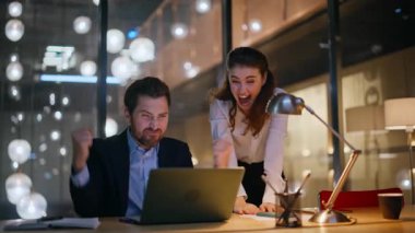 Heyecanlı acemiler gece ofisinde dizüstü bilgisayar görünce mutlu oluyorlar. Akşamları birlikte çalışarak para kazanan duygusal iş arkadaşları. Aşırı neşeli iş insanları iş yerinde başarıdan zevk alırlar..