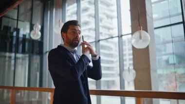 Girişimci, modern ticaret merkezini zoom yaparak akıllı telefon görüşmesiyle projeyi tartışıyor. Kendine güvenen sakallı iş adamı telefonda el kol hareketi yapıyor. Zarif yönetici cep telefonuyla pazarlık yapıyor..