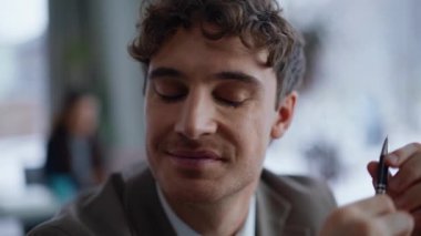 Hayalperest iş adamı modern ofiste kalem arama mesafesinde. Gülümseyen gevşemiş profesyonel yönetici iş yerinde başarılı olacağını umuyor. Mutlu şirket yöneticilerinin iş molası var.