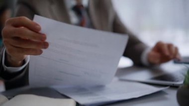 Ofiste bilgisayarda klavye yazan eller yakın plan. Sırıtkan avukat, laptopta oturan grafiklerin bilgilerini karşılaştırıyor. Kapalı alanda belgelerle uğraşan odaklı yönetici