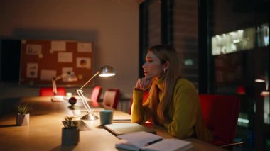 Depresyonda olan çalışanlar, gece ofislerinde oturuyorlar ve bilgisayarları kapatıyorlar. Karanlık işyerindeki finansal krizi düşünerek umutsuzluğa kapılmış bir iş kadını. Fazla mesai yapmak istemeyen üzgün bir kadın.