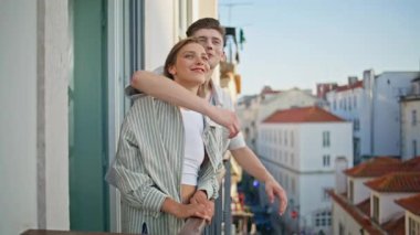 Sevecen insanlar terası kucaklıyor. Çok mutlu bir çift güzel bir şehre benziyor. Birlikte huzurlu bir akşamın tadını çıkarıyorlar. Neşeli aşıklar gülüyor, balkonda dinleniyorlar. Sevimli mutlu sevgililer sarılıyor