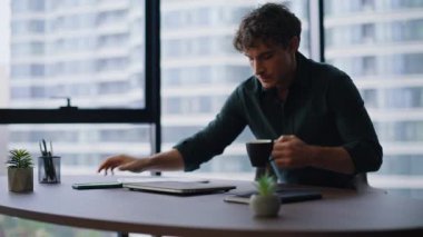 Genç işadamı işe koyulmaya başlar. Ofis masasına oturur, kahve fincanını kapatır. Ciddi yönetici verimli bir iş akışı için dizüstü bilgisayar açıyor. Sabahları kafein içen profesyonel bir çalışan.