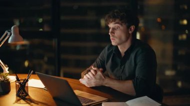 İş koçu, gece iş yerindeki video konferansında konuşuyor. Profesyonel yönetici projeyi karanlık ofiste video görüşmesiyle sunuyor. Sanal toplantıda şirket danışmanı işi açıkladı. 