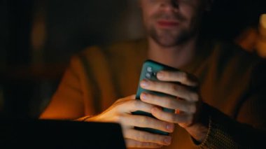 Karanlık ofiste cep telefonuyla mesajlaşan geç çalışan bir işçi. Geceleri uzaktan kumandalı işyerinde cep telefonu tutan serbest çalışan eller. Akıllı telefondaki mesajları okuyan profesyonel bir çalışan fazla mesaiye ara veriyor.