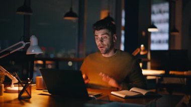 Uzaktan kumandalı çalışan bilgisayarlı web kamerasıyla sıkı çalışma konularını tartışıyor. Endişeli bir yönetici, gece işyerinden arıyor. Endişeli iş adamı çevrimiçi sanal toplantıda konuşuyor.