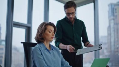 Erkek sekreter, şirket işyerinde imza attığı için kadın patrona rapor veriyor. Belgelere imza atan kendine güvenen bir iş kadını. Sakallı asistan gülümseyen CEO 'ya kağıtları açıklıyor..