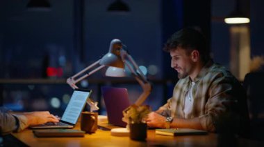 Şirket danışmanı, gece masasında iş birliği yapan stajyerler. Ofise giren zarif bayan çalışma alanında konuşan takım üyelerine rehberlik ediyor. Proje değerlendirmesini akşam işyerinde tartışan ciddi profesyoneller