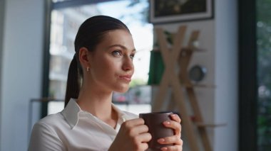 Sakin bir çalışan kahvesini yudumlarken şirket ofisinde iş molası veriyor. Kapuçino içen iş kadını portresi, üzerinde kafa yoruyor. Zarif kadın girişimci sabah işyerinde tek başına dinleniyor.