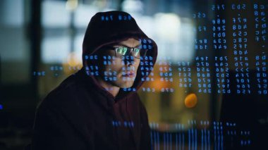 Yakın plan hacker web sitesinin kod satırları neon projeksiyonu. Kapüşonlu adam veri hologramındaki siber güvenliği kırmaya çalışıyor. Karanlık odada yazılım zayıf noktalarını bulan bir adam. Siber suç kavramı
