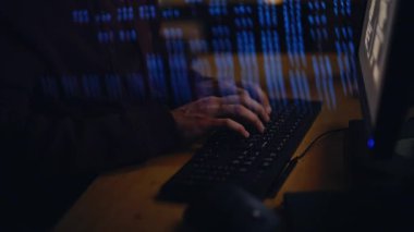 Programcı eller veri yansıma odasında klavyeyi kodluyor. Kapüşonlu, kapalı mekanda kodlarla çalışan çok çalışan ciddi bir adam. Karanlık atmosferdeki virüsten uzman temizlik sistemi. 