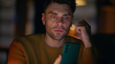 Fazla mesai yöneticisi cep telefonuyla karanlık ofis odasında tek başına oturuyor. Akşamları internette cep telefonu uygulamasına bakan düşünceli bir adam. Akıllı telefondan e-posta okuyan ciddi girişimci.