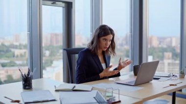 Dizüstü bilgisayarın web kamerasındaki kağıtları gösteren sanal konferansta idari tartışma. İnternetteki toplantıda tartışan stresli iş kadını hayal kırıklığına uğramış bir rapor sunuyor. Öfkeli kadın CEO şikayet videosu arıyor..