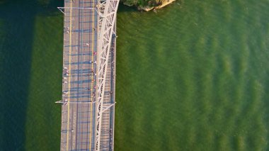 People walking bridge in Porto aerial top view. Pedestrian part of Dom Luis metal construction over calm surface river Douro in Portugal. Beautiful architecture connecting city banks. Tourism concept