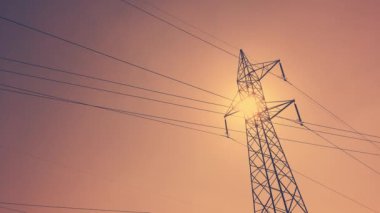 Işıldayan kabloları olan elektrik iletim kuleleri