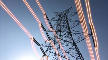 Electricity transmission towers with glowing wires