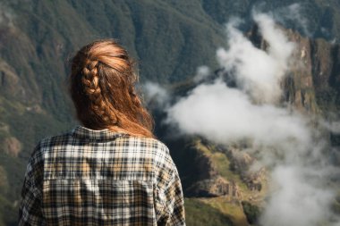 Traveler with Braided Hair Admiring Machu Picchu in Peru clipart