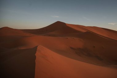 Merzouga, Fas 'ta nefes kesici bir gün batımı sırasında erg chebbi kumullarının renk değiştirmesinin çarpıcı görüntüsü