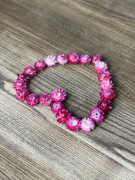 Tahta bir masa arkasında kalp, pembe kalp., 