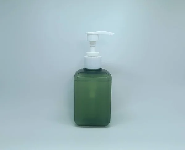 white plastic bottle with liquid soap on white background