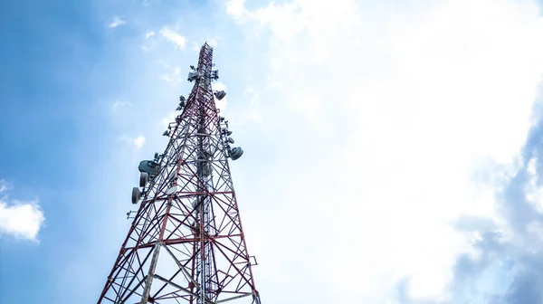 Stock image Telecommunication tower under cloudy and blue sky. Wireless communication and information technology concept