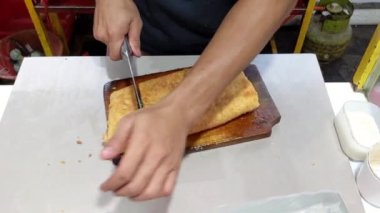 Sinematik çekim. Yumurta, et ve soğan yaprağıyla doldurulmuş Martabak Telor olarak bilinen lezzetli tavada kızartılmış hamur işleri. Endonezya mutfağının tanınmış yemeklerinden biri.