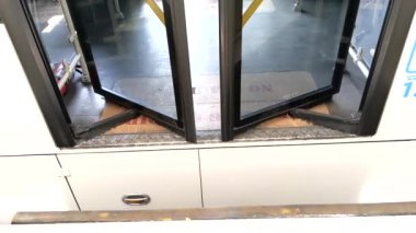 Slow motion of automatic bus doors close at the shelter stop. Modern public tranport concept