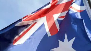 Low angle and cinematic shot of the Australian National flag fluttering in the wind. Patriotism and nationalism concept