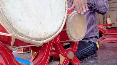 Sinematik çekim. Kendang denen geleneksel java vuruşlarını döven Asyalı yaşlı bir adamın elleri.