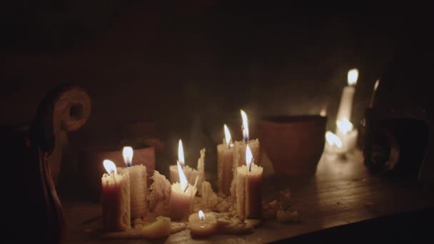 Old Rough Wooden Table Which Many Wax Candles Burning Dishes — Stock Video