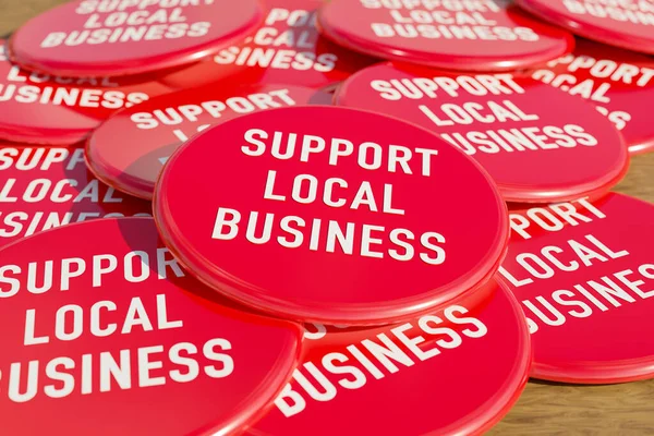 Support Local Business badge. Red badges laying on the table with the message \