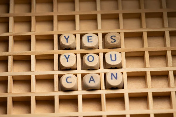 Yes you can. Wooden dice arranged in a box, to the text, yes you can. Motivation, inspiration and information.